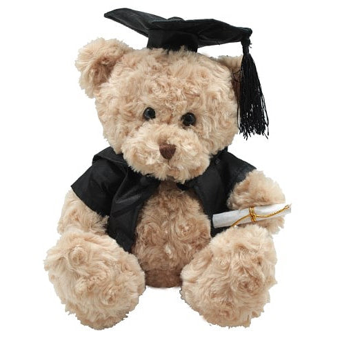 A beige teddy bear wearing a black graduation cap and gown, holding a scroll, seated against a white background.