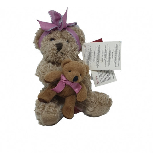 A brown teddy bear with a pink ribbon holding a smaller brown teddy bear with a pink bow, with a 'Russ Berrie & Co' tag and a pink bow on its head.